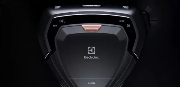 Close-up view of an Electrolux robotic vacuum cleaner, showing its logo and control buttons for eco mode, spot cleaning, and home function on a glossy black surface.